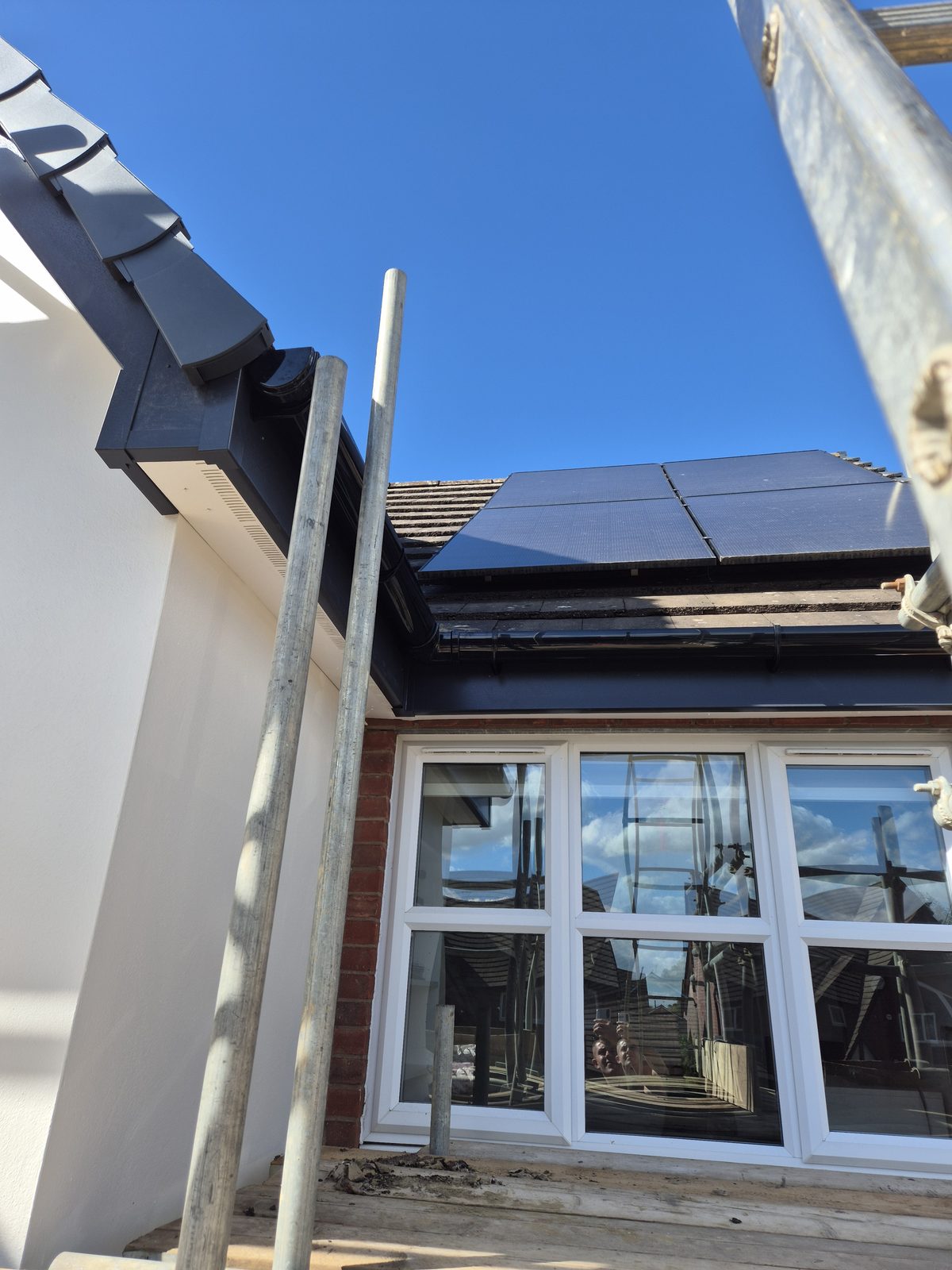 Roof with solar panels and refurbished guttering and fascia